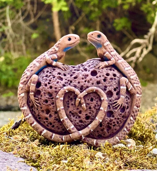 Laura Ames hand sculpted ceramic lizards on a ceramic lava rock.