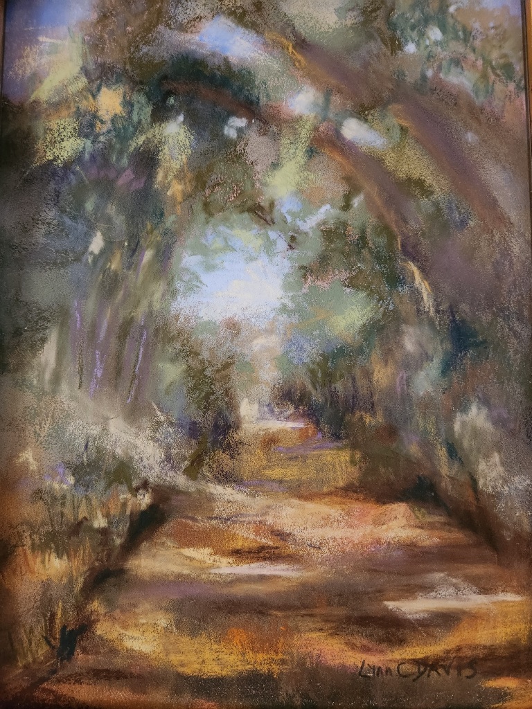Lynn C Davis pastel landscape of shaded path at Spring Lake. Browns, golds and blues