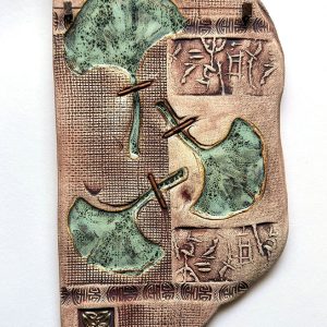 Margaret Bolt's Clay wall plaque with glaze and bamboo wrapped copper wire titled Sacred Ginko