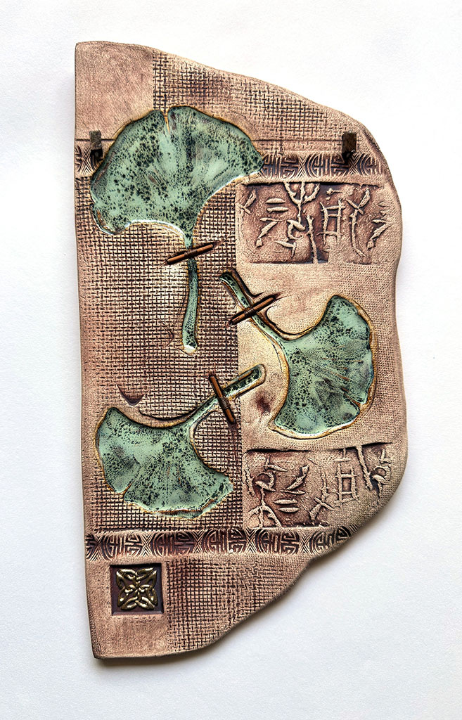 Margaret Bolt's Clay wall plaque with glaze and bamboo wrapped copper wire titled Sacred Ginko