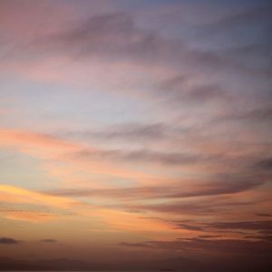 Tim Burns' photograph of cloudy sunset. Soft pinks, oranges and blues. Fuji Color crystal archive DP II acrylic glass (matte) maple frame