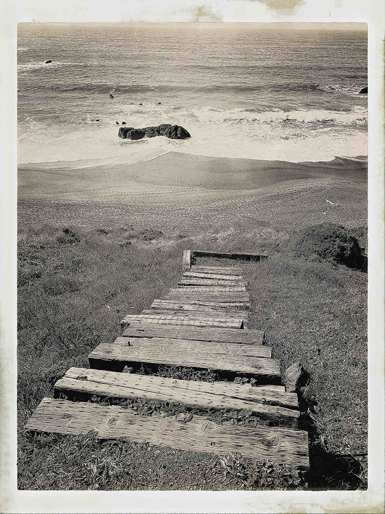 Monica Kuhlman Jacobson's black and white photograph of wood steps leading to the beach