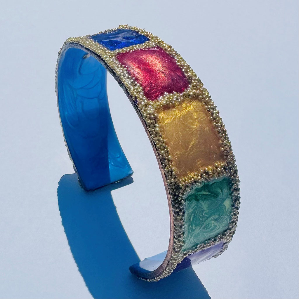 Ava Austin's copper enameled bracelet in red, blue orange teal