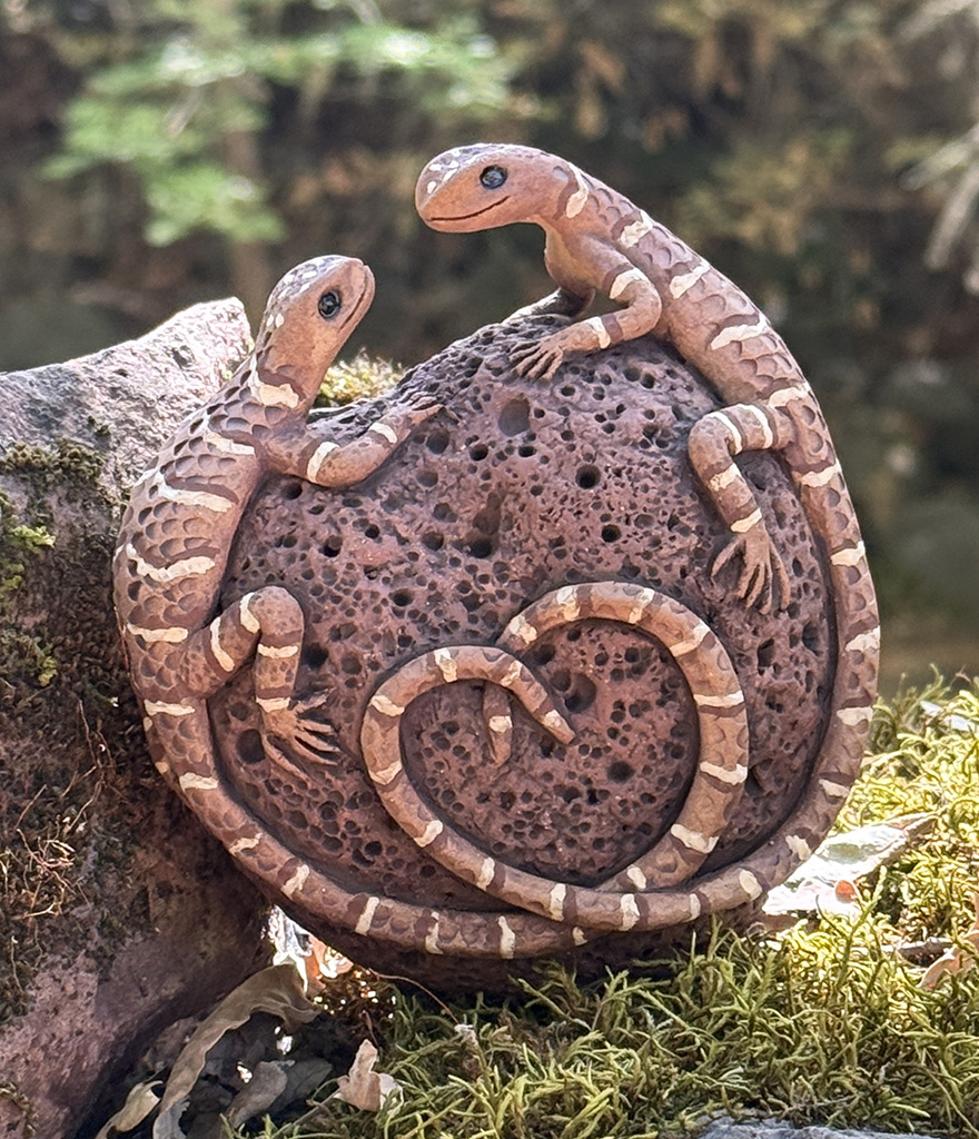 Laura Ames' Hand sculpted lizards on ceramic lava rock rattle in soft pinks and browns