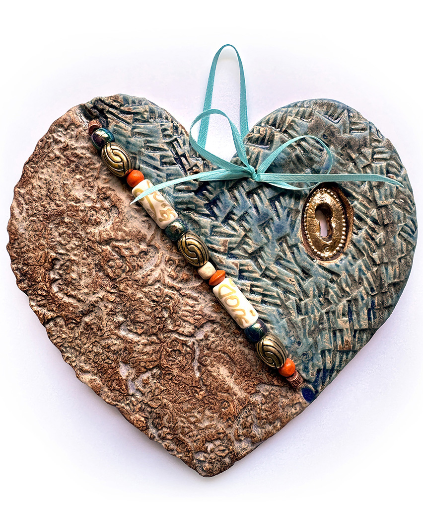 Maggie Bolt's clay wall plaque with beads and gold enamel in browns and teals
