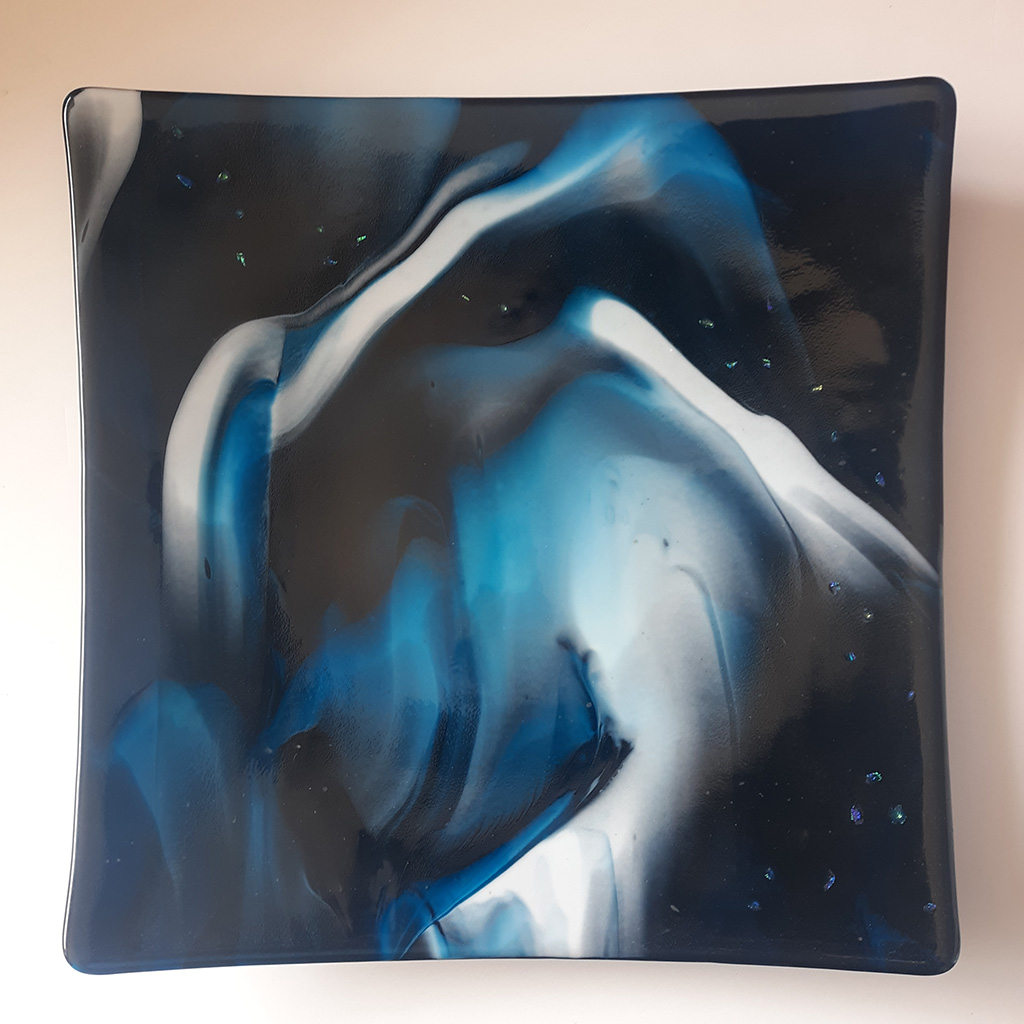 Brian and Nancy Roberts fused glass square Cosmos is transparent with dark blues, whites and blacks. Can be backlit or viewed on a table
