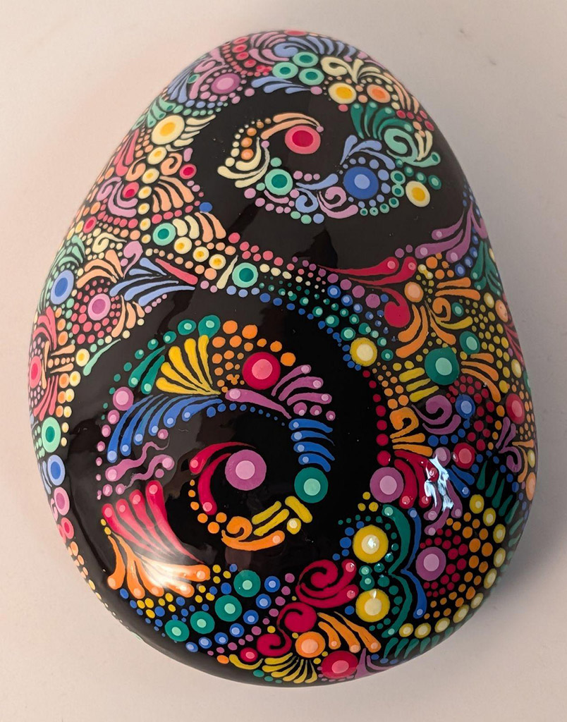 Gretchen O'Bleness' Acrylic paint on black Idaho river rocks, sealed with resin in the Dot Mandala style