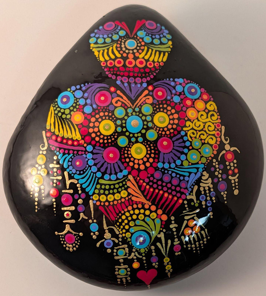 Gretchen OBleness' painted river rock Acrylic paint on Idaho river rocks, sealed with resin in the Dot Mandala style